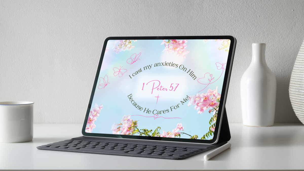 Tablet on a stand showing the 1 Peter 5:7 Christian wallpaper with its floral design